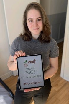 Gabriela holds a tablet showing the enuf logo and the words "Because "WASTE" is a social construct!" #CUcompost